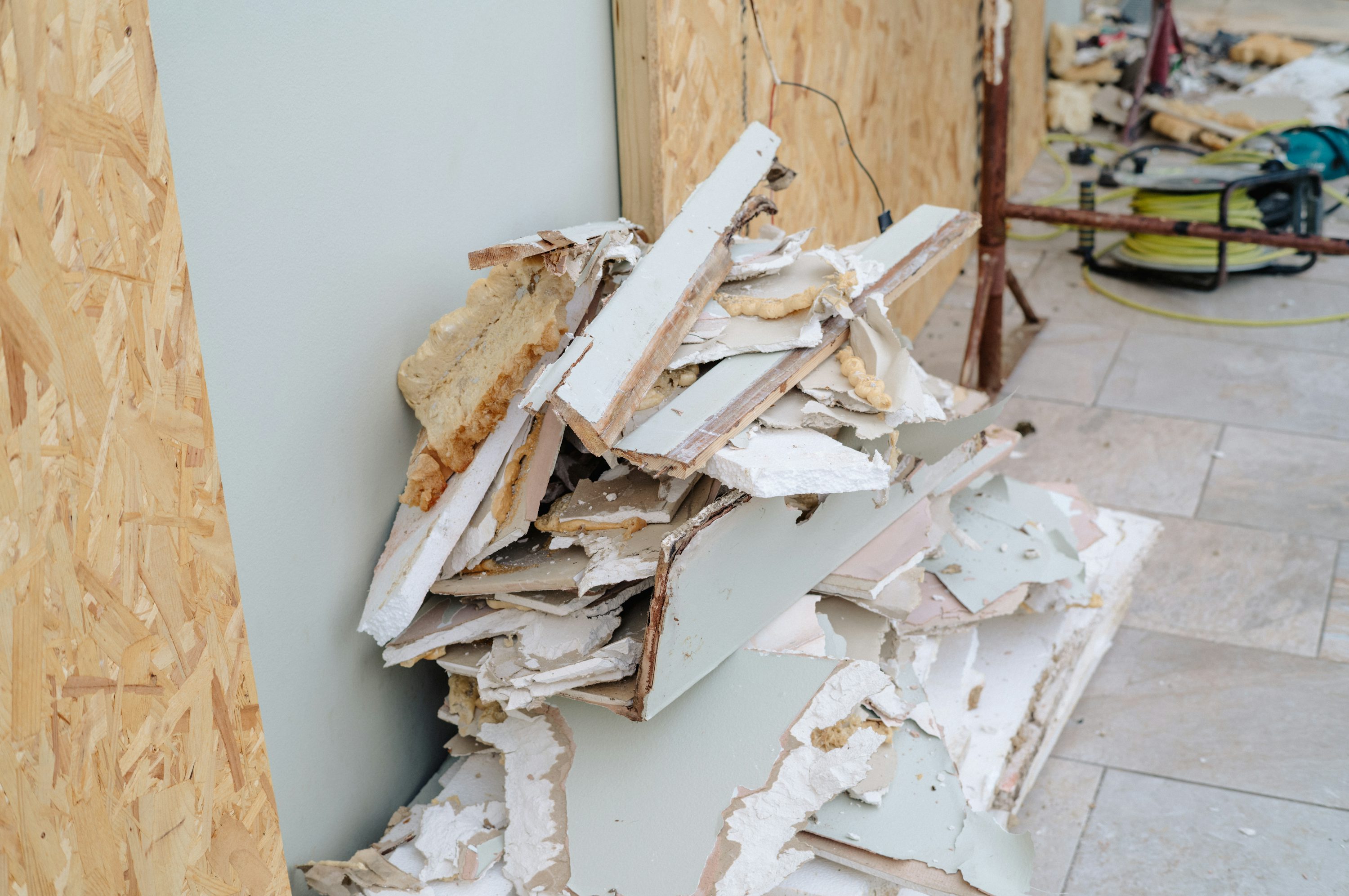 A pile of drywall and leftover construction materials
